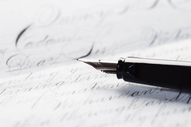 inkwell and fountain pen on white paper