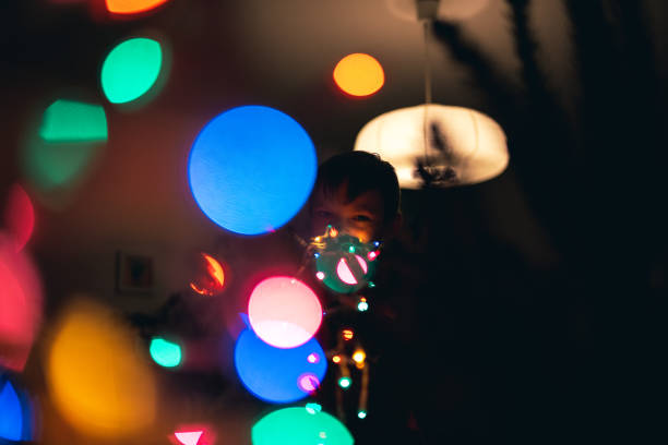 istock Boy Decorating Christmas tree at home 1199481725