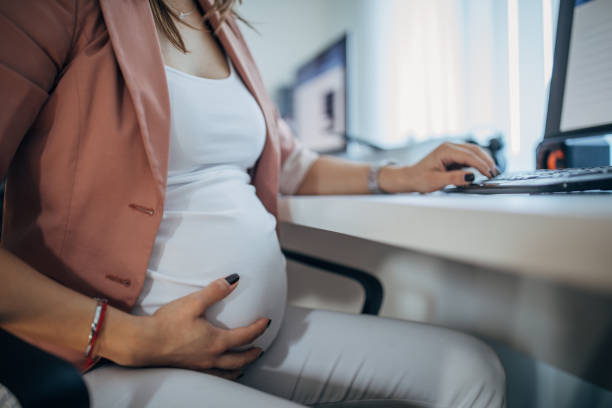 istock Pregnant woman at the office 1199484673