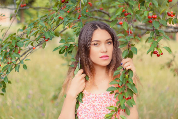 istock Woman Picking Cherries 1199485478