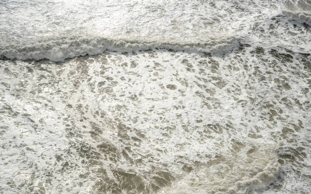 istock Seashore with wavy ocean and wind waves crashing on the rocks. 1199486057