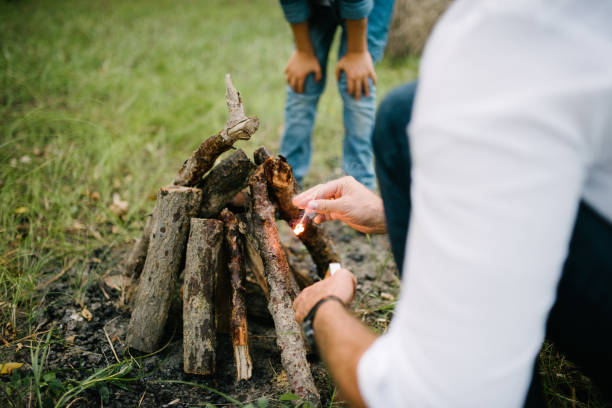 istock A man makes a fire in the forest in the summer afternoon 1199486686