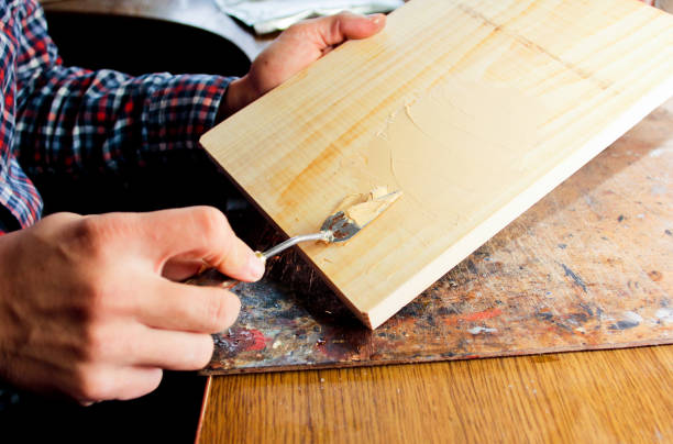istock Putty knife in man's hand. The process of plastering in the workshop. 1199486796