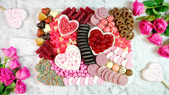 Happy Valentine's Day flat lay overhead candy and cookies dessert charcuterie grazing platter.