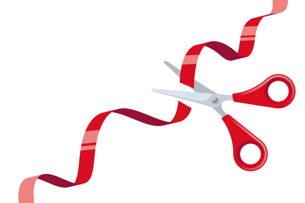 istock Cut Red Ribbon and Stainless Steel Scissors with Red Handles over White Background 1199487912
