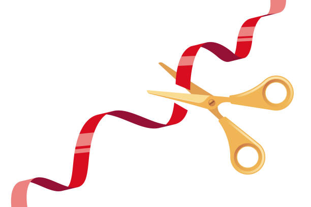 istock Cut Red Ribbon and Golden Scissors over White Background 1199487920
