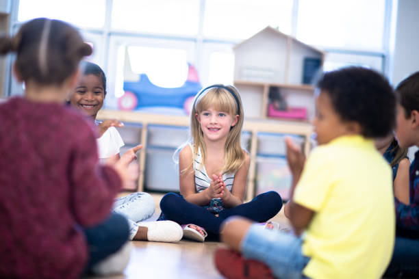 istock Kindergarten Class Singing and Clapping During Circle Time stock photo 1199489140