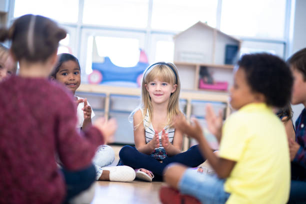 istock Kindergarten Class Singing and Clapping During Circle Time stock photo 1199489150