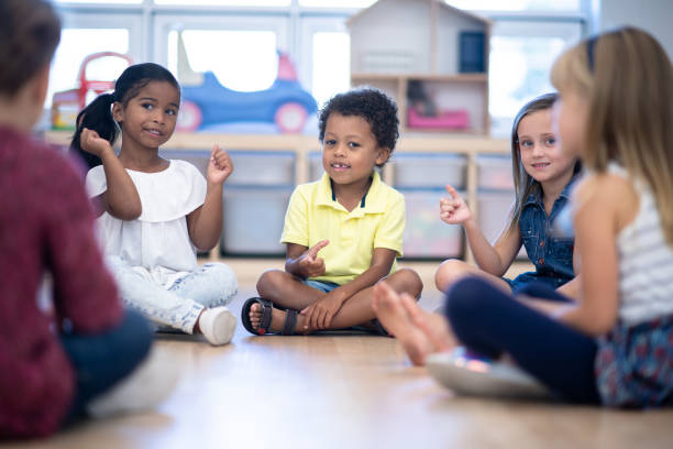 istock Kindergarten Class Singing and Snapping During Circle Time stock photo 1199489154