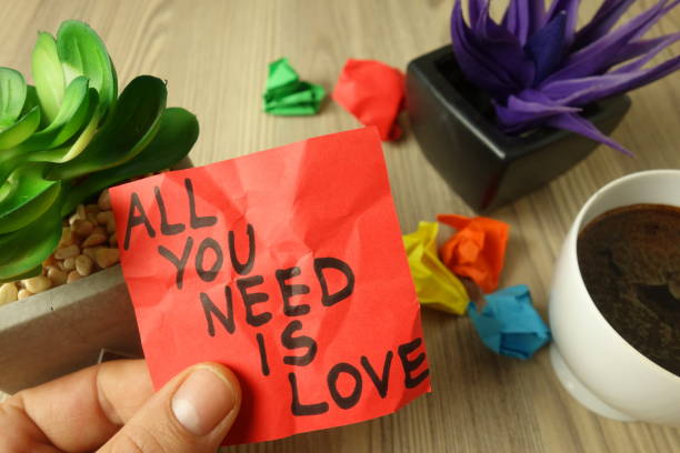 istock Slogan all you need is love handwritten on sticky note 1199490070