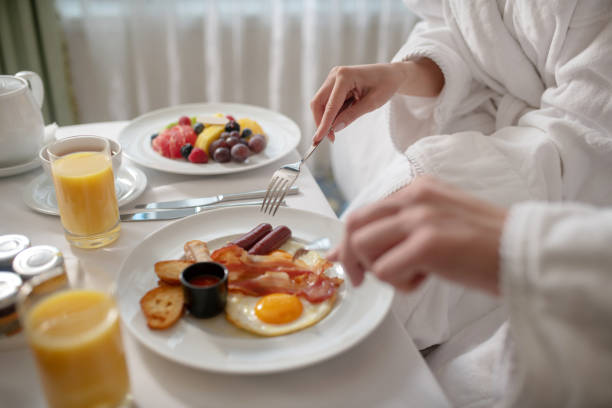 istock Young couple eating nutritious English breakfast together 1199491419