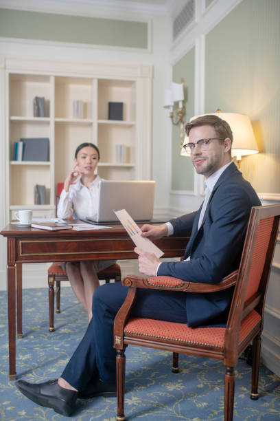 istock Man providing his female boss with a report 1199491592