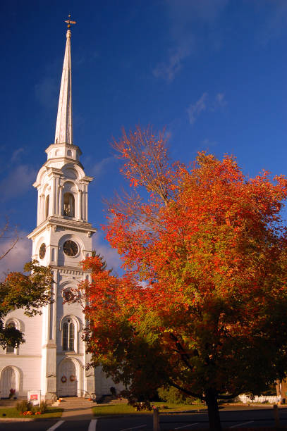 istock Autumn colors frame a classic white church 1199491835