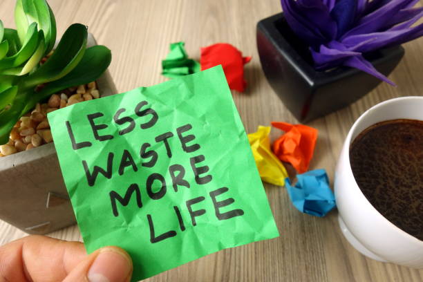 Slogan less waste more life handwritten on sticky note