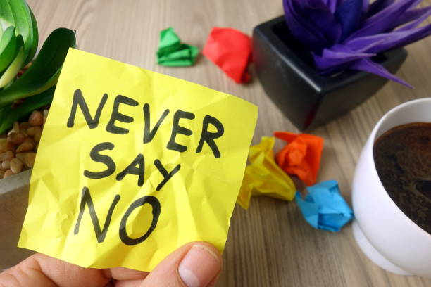 istock Slogan never say no handwritten on sticky note 1199492181