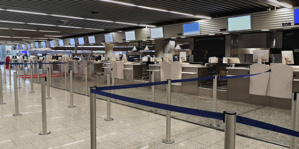 istock Frankfurt,Germany,12 26 2019.Empty check-in counters with computers,monitors luggage scales,drop off counters.Concept of transition to online check-in and reducing staff at airports 1199492213
