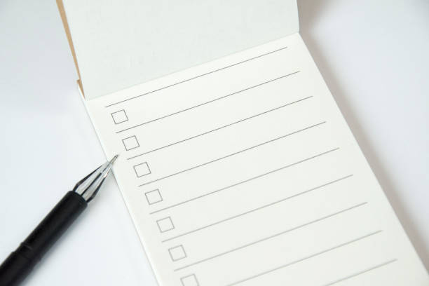 istock Blank to do list planner with checklist and black pen on white background, close up view 1199492933