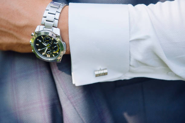 istock A man in a suit adjusts the clock on his hand close up. 1199493450