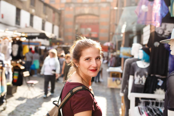 Tourist woman in a street market Tourist woman in a street market camden market stock pictures, royalty-free photos & images