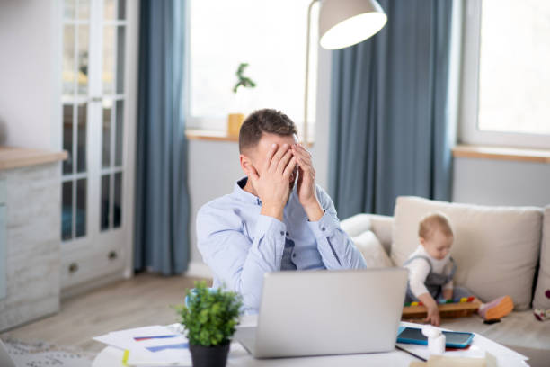istock Bearded man in a blue shirt having a headache 1199495934
