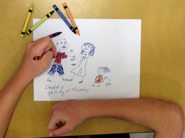 child drawing sad family child's hands coloring her drawing showing father shouting at mother, child crying christine kohler stock pictures, royalty-free photos & images
