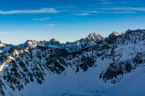 istock Winter mountain landscape. Peaks illuminated by the setting sun. 1199496296