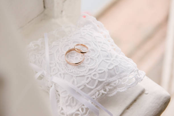 istock Wedding rings lie on a cushion for wedding rings close up 1199498162