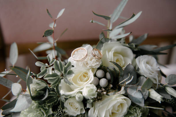 istock Wedding rings lie on a flower close up 1199498163