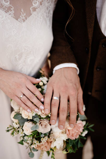 istock Man and woman hold hands close up 1199498330