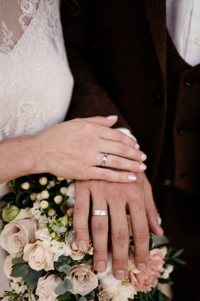 istock Man and woman hold hands close up 1199498358