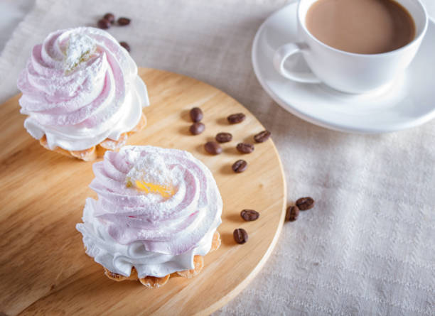 istock Cakes with whipped egg cream on wooden board, selective focus, close up. 1199498920