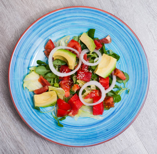 Healthy summer salad with watermelon, avocado, tomatoes, grapefruit and corn salad
