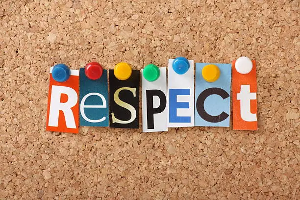 The word Respect in cut out magazine letters pinned to a cork notice board