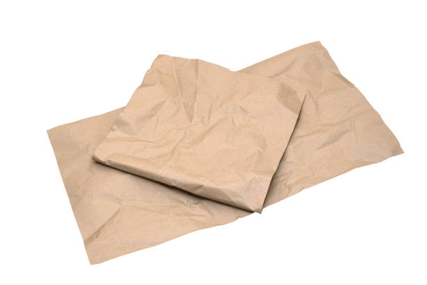 istock Crumpled kraft wrapping paper sheets isolated on white background. Packaging and recycled materials concept. Copy space 1199504222