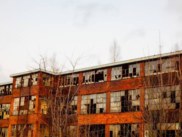 istock Old factory with broken windows 1199506435