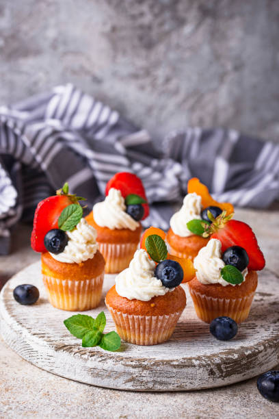 istock Cupcakes with cream and berries 1199507878