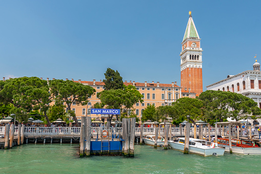 View of the lagoon with Campanile on Piazza di San Marco and water bus ( vaporetto ) stop, Venice, Italy.