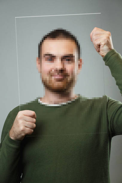 Portrait of a man covering his face with a pixel frame Portrait of a man covering his face with a pixel frame. pixelated photos stock pictures, royalty-free photos & images