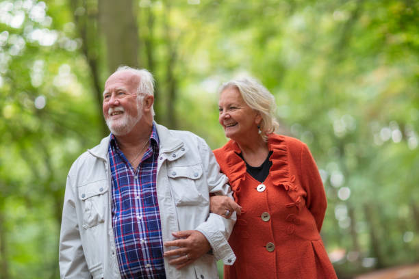 istock Senior couple out for a walk in the forest 1199510452