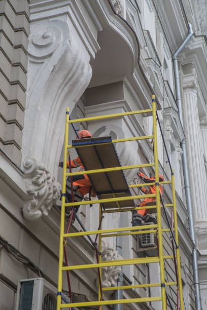 istock Workers restore the facade of an building 1199510953