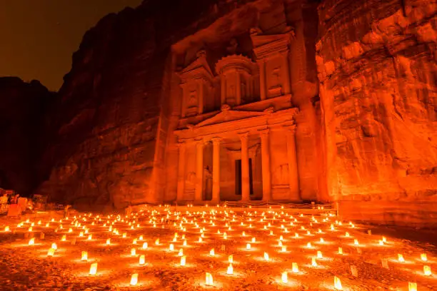 Photo of Petra by night (candlelit) and the Treasury monument (Al Khazneh) in Petra archaeological site, Jordan.