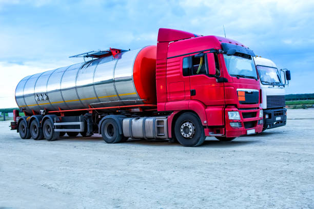 istock trucks on parking against summer landscape 1199511686