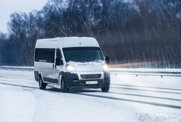 istock Minibus moves in the winter on a highway 1199511701