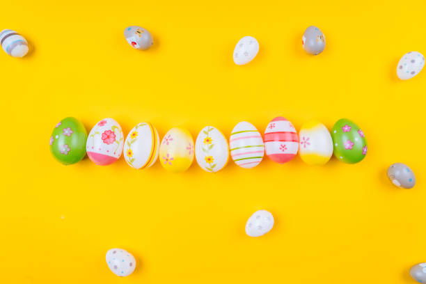 istock Colorful easter painted eggs background on yellow pastel color background with space. 1199513928