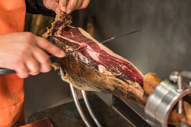 istock Cutting the traditional Serrano Spanish leg ham. 1199515121