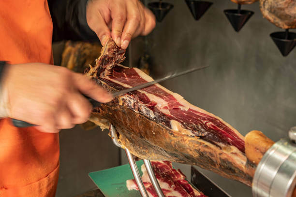 istock Cutting the traditional Serrano Spanish leg ham. 1199515135