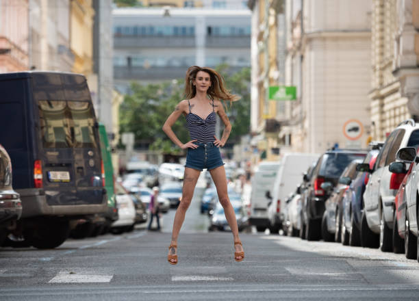 Cool young woman with tattoos,jumping, hovering