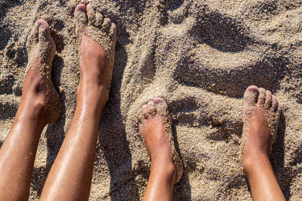 istock Kids foot in sand 1199517476