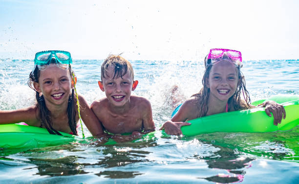 istock Kids in the sea 1199518050
