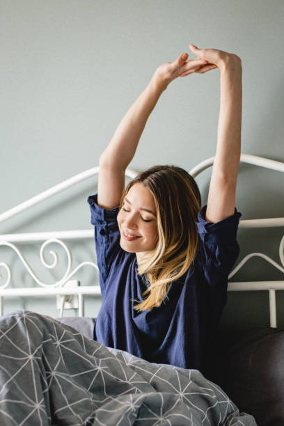 istock Young woman is waking up 1199520303